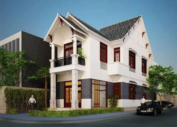 Mẫu nhà ống 2 tầng trắng đẹp tại khu dân cư, có mái ngói và cửa sổ gỗ.